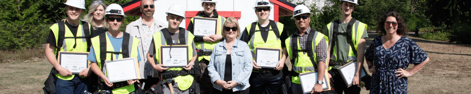 Construction Academy Graduates in front of Playhouse they built
